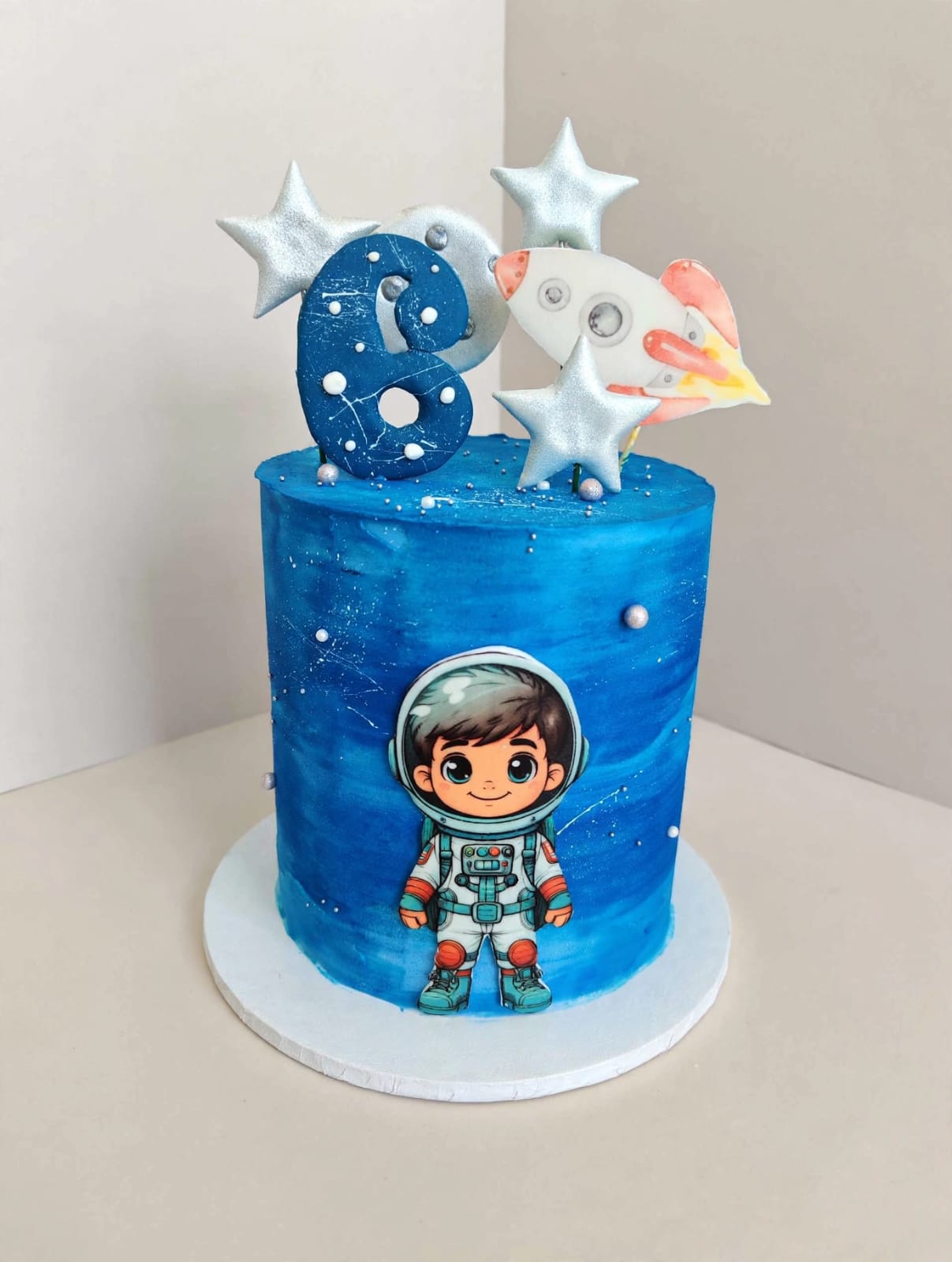 Space themed kids birthday cake with astronaut