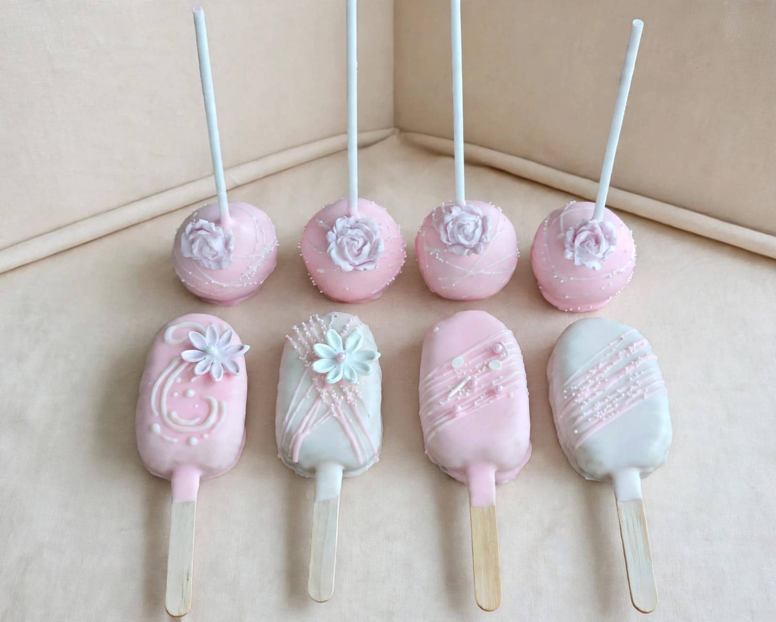 Pink and white cake pops and cakesicles with sugar roses