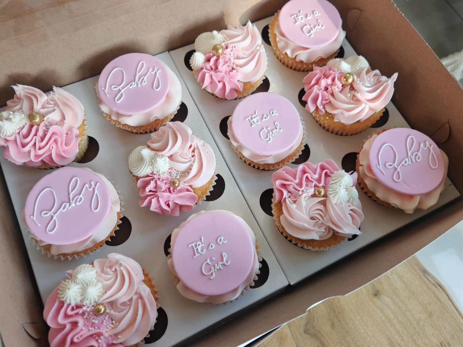 Pink piped cupcakes with sugar flowers